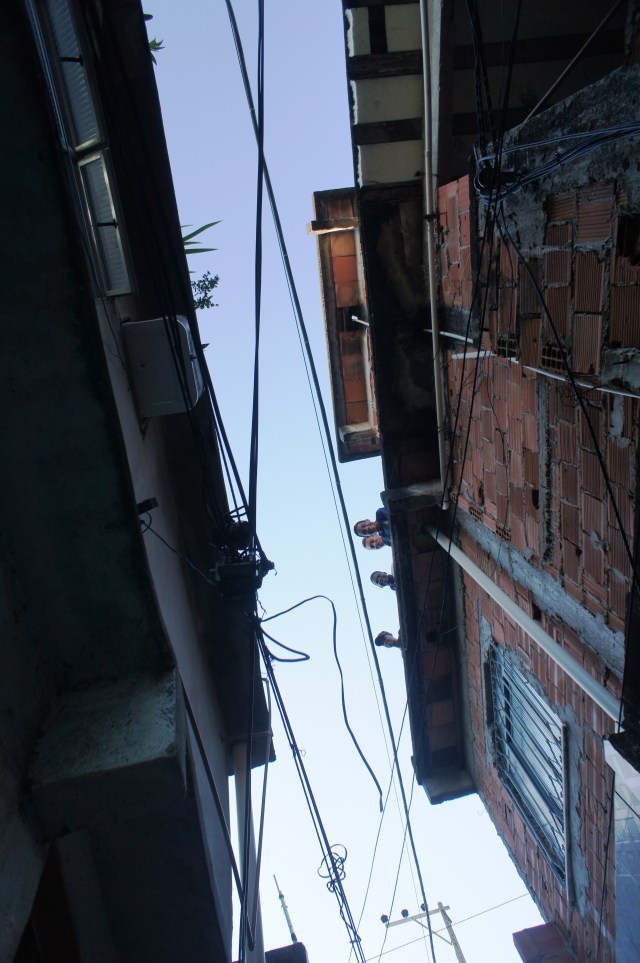 Kite-flyers take a break to take a look down, at tourists