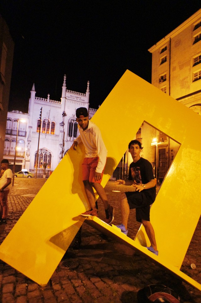 Outside the stage door, post-performance: passinho kids play on Retangulo Vazado by sculptor Franz Weissman, just in front of the Royal Portuguese Reading Room, completed in 1887, only a year before slavery was abolished in Brazil